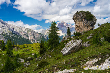 Very beautiful landscape. High Dolomite cliffs, mountains covered with green vegetation and small...