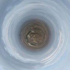 Little planet transformation of spherical panorama 360 degrees. Spherical abstract aerial view in blue sky with clouds. Curvature of space.