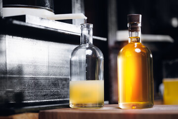 Manufacturing fresh extra virgin organic oil from sunflower by press, industry production. Concept food healthy eco product