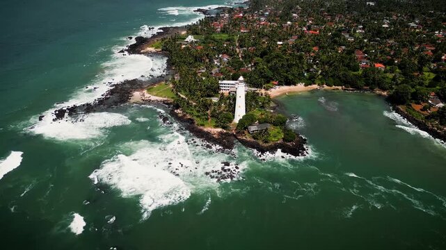 Aerial view of Dondra Lighthouse in Sri Lanka, color graded for a cinematic feel, beautifully capturing the coastal landscape and historic landmark