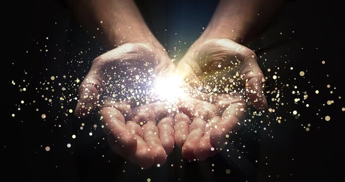 Hands, praying and lights shine for enlightenment, magic or spiritual realm on black background. Person or astrologer for hope, future or fortune telling with bokeh glow for palm reading in astrology