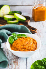 Delicious squash caviar and basil in a bowl on the table vertical view