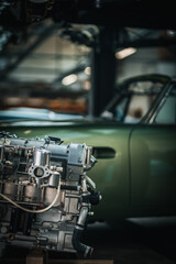 Fototapeta premium Newly restored engine for a classic car in a background stored in a vintage car restauration garage.