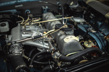 Obraz premium Engine under the bonnet of a classic motor which undergoing full restoration