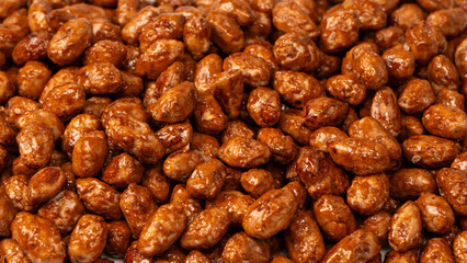 Tasty sweet roasted peanuts as a background.