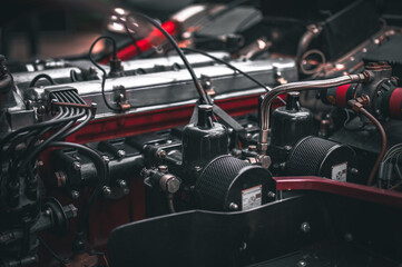 Engine under the bonnet of a classic motor which undergoing full restoration