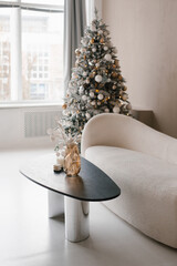 White couch is in front of a Christmas tree in modern living room