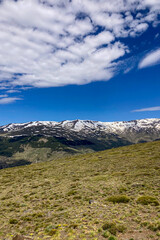 Obraz premium Panoramic view on snowy mountains on hiking trail to Mulhacen peak in the spring, Sierra Nevada range, Andalusia, Spain