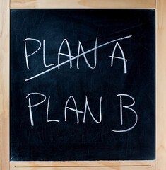 Crossing out PLAN A going PLAN B chalkboard blackboard. Crossing out PLAN A on a chalk board and going for PLAN B isolated on white background. Please visit my personal blackboard collection