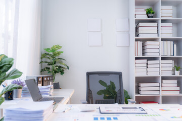 Minimalist Modern Office Workspace: A sleek and airy office space with a clean, minimalist design. Natural light floods in through the large window, illuminating a tidy desk with a laptop, documents, 