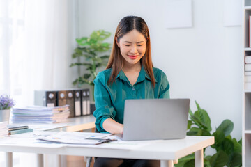 Focused Asian Businesswoman in Home Office