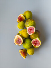 Yellow figs on a white background. Whole and halved figs