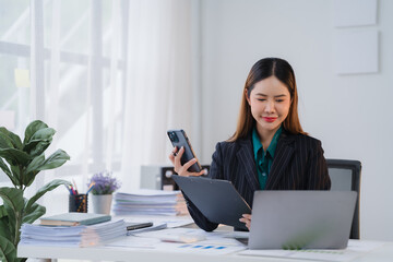 Focused Asian Businesswoman Multitasking at Work 