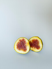 Yellow figs on a white background. Whole and halved figs