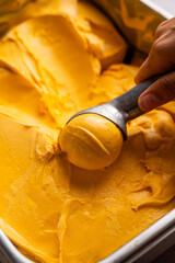 Mango icecream being scooped 