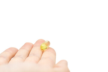 Male hand holding omega 3 soft gel capsule isolated on white background