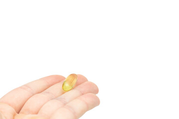 Male hand holding omega 3 soft gel capsule isolated on white background