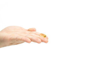 Male hand holding omega 3 soft gel capsule isolated on white background