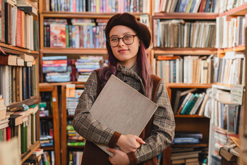 Portrait of an attractive cheerful 20s female hipster girl high school pupil college student...