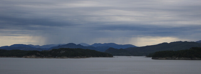 Rain cloud over mountain ranges near Bergen, Norway.