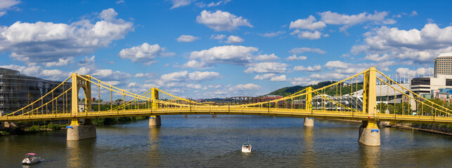 Panoramic view of row of yellow bridges on Alleghany river at Pittsburgh.