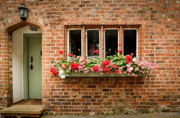 Front of a cottage with a window box full of flowers