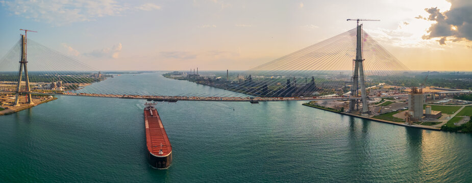 A barge under newly constructed Gordie Howe International Bridge across the USA and Canada border at Detroit downtown.