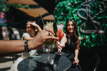 Multicultural businesspeople enjoying drinks and cheering for success in an outdoor cafe. Celebrating team achievement and friendship.