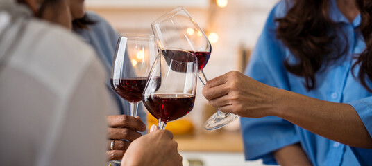 Friends Cheers wine glasses in kitchen. Reunion friendship greeting concept holidays, party and celebration concept