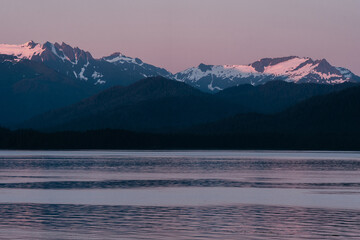 Sunset on mountain range along Southeast Alaskan coastline along the inside passage in summer