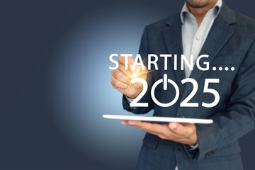loading or starting new year 2025 on virtual screen and a man having tablet touching it.