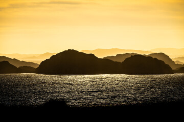 Sea haze in a rocky landscape at sunset.