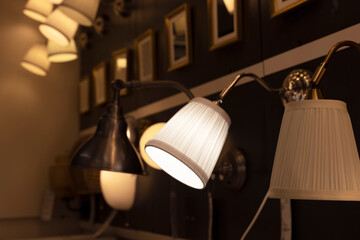 A row of lamps with one of them having a white shade