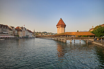 View of the chapel bridge at sunset in Lucerne, Switzerland.