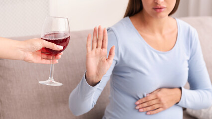 Alcohol In Pregnancy. Unrecognizable Expectant Lady Gestring Stop To Offered Glass Of Wine Sitting...