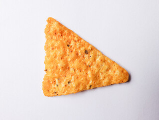 One corn chip or tortilla chip is triangular in shape on a white background.