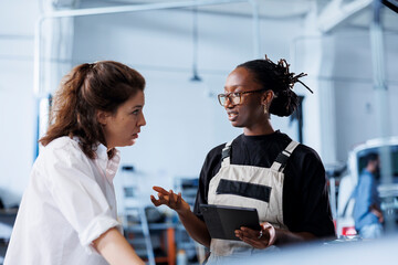 Meticulous mechanic at auto repair shop conducts annual vehicle checkup, informing client about...