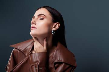 Portrait of passionate celebrity weating precious jewelry isolated on dar grey color background