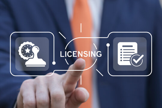 Business man using virtual touch interface presses word: LICENSING. License agreement business technology concept. Copyright protection law license property rights.