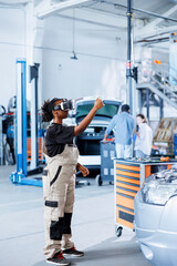 Certified mechanic in repair shop using VR googles and augmented reality hologram to visualize car...