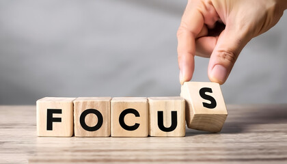 Focus management concept. hand put focus word on wooden block cube