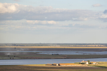 Tagus river winding through vast landscape with farm and salt marshes