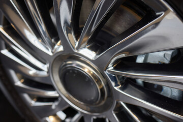 Detailed shot of a sleek black and silver alloy wheel on a motor vehicle