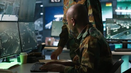 Team of military officers using tracking equipment to gain info helpful against enemies. Teamworking army colleagues trying to gain intel helping troops, coordinating mission activities, camera A
