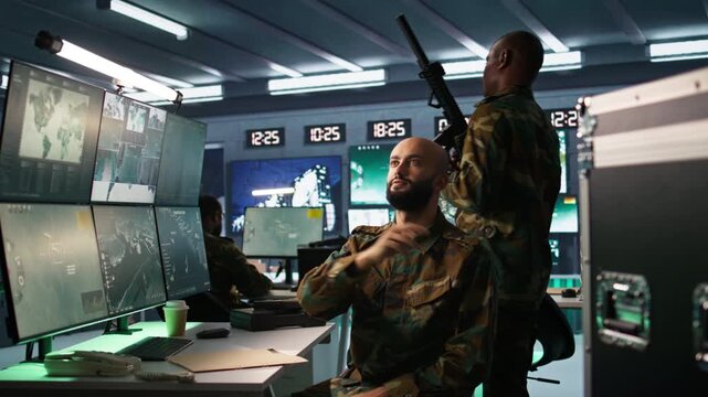 Military agent using augmented reality tech in control room, analyzing aerial reconnaissance data. Intelligence corps expert controlling drones attacking strategic targets using AR hologram, camera B