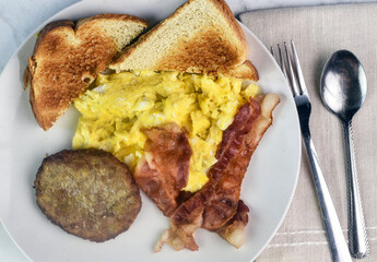 scramble eggs   with home fries, bacon sausage and toast