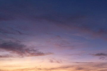 A serene evening sky with soft hues of purple, pink, and orange, fading into twilight