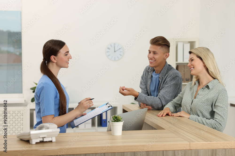 Wall mural Professional receptionist working with patients in hospital