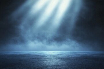 Fototapeta premium Abstract blue light rays illuminating foggy dark space with spotlight on empty asphalt floor, creating a mysterious atmosphere for product presentation or branding concepts.