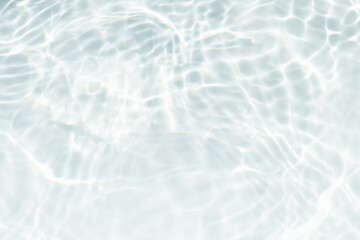 White water with ripples on the surface. Defocus blurred transparent white colored clear calm water surface texture with splashes and bubbles. Water waves with shining pattern texture background.